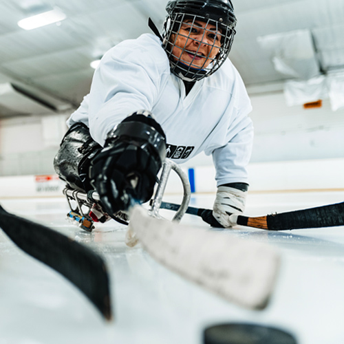Woman playing sled hockey
